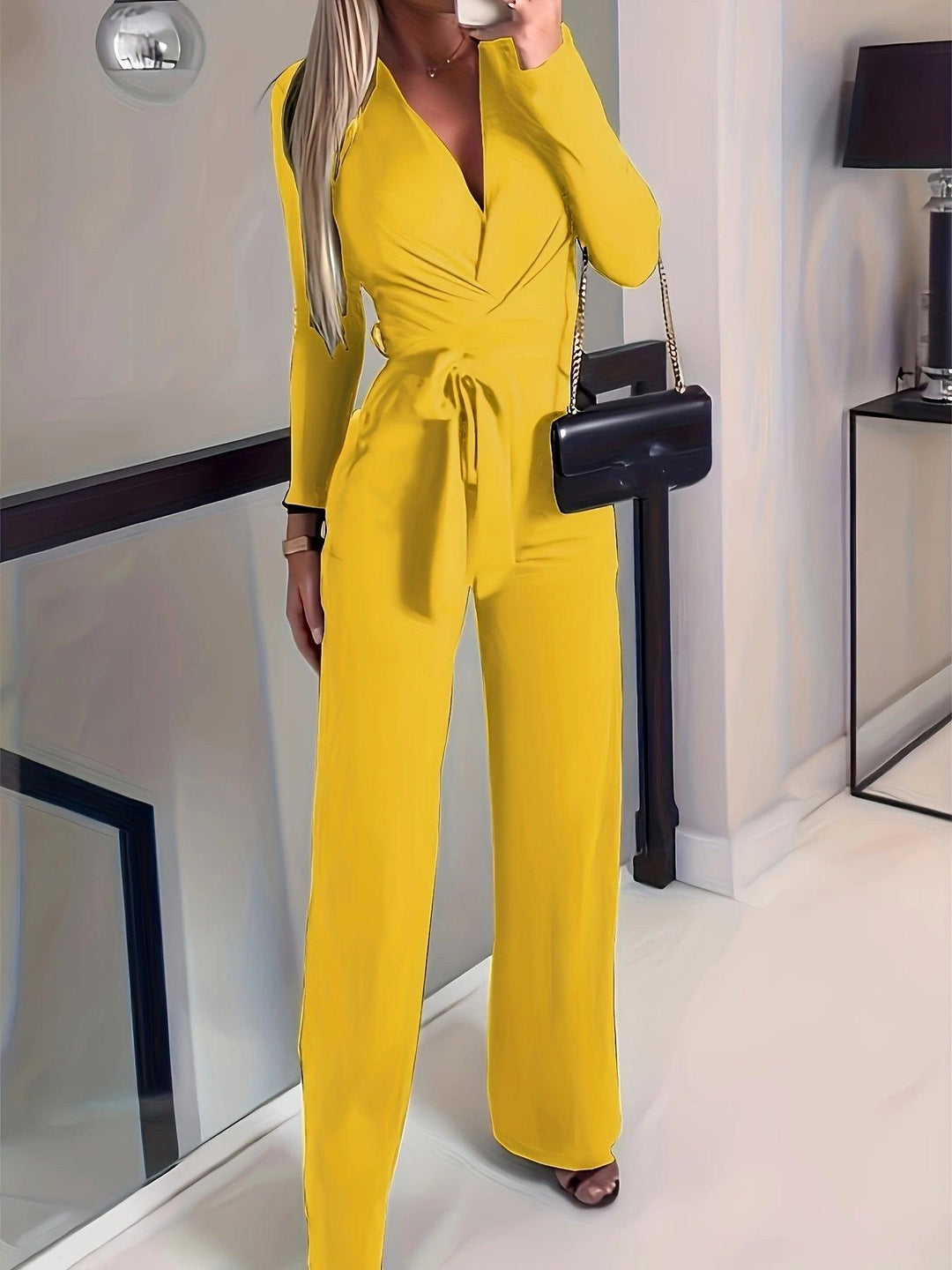 Women's yellow V-neck long-sleeve jumpsuit with tie waist and wide-leg pants