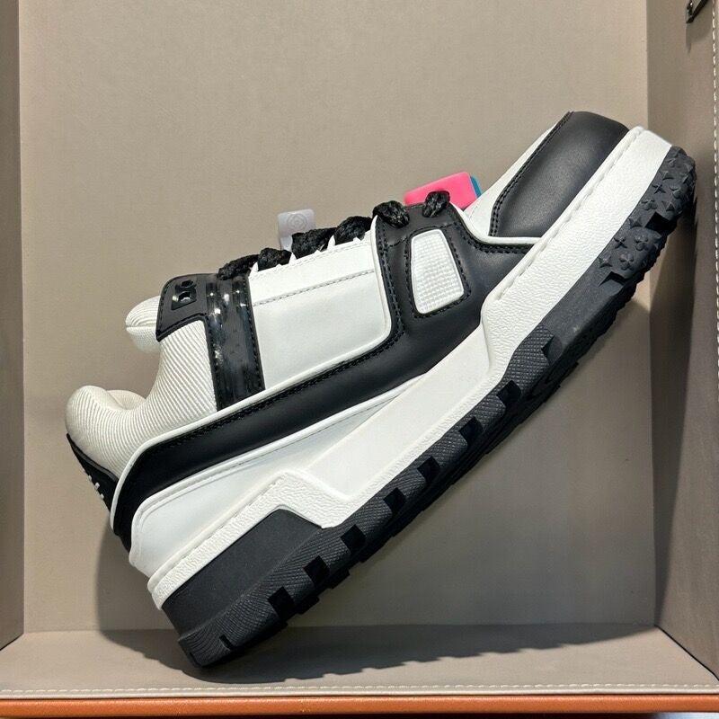 Black and white thick-soled sports board shoe with velcro straps and chunky tread