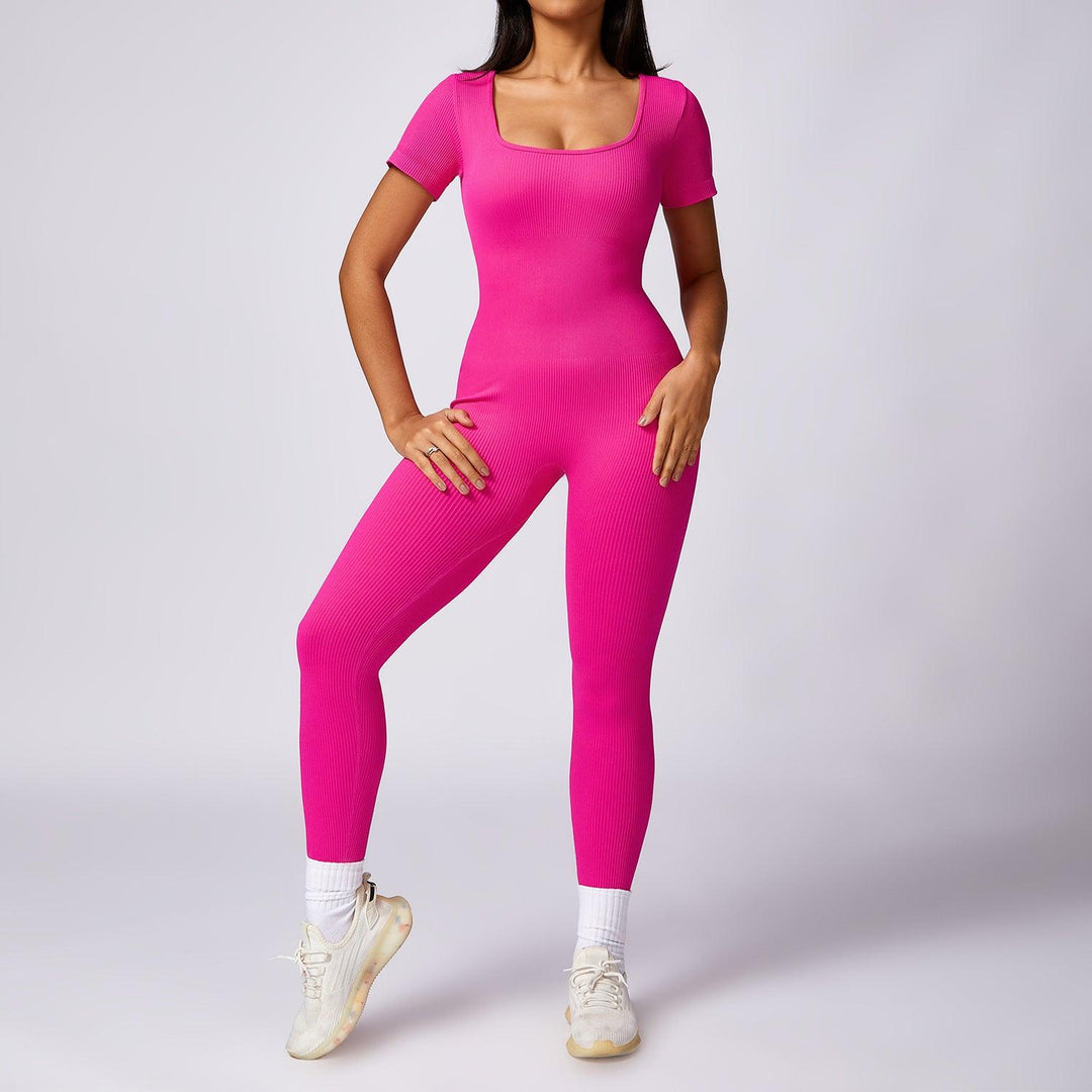 Pink seamless one-piece bodysuit with short sleeves and square neckline, full-length legs