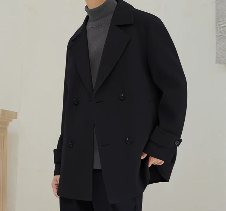 Men's black wool trench coat with peak lapels and double-breasted button front, side profile