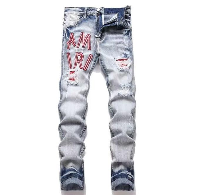 Light blue slim jeans with red “AM IR” text and distressed ripped details