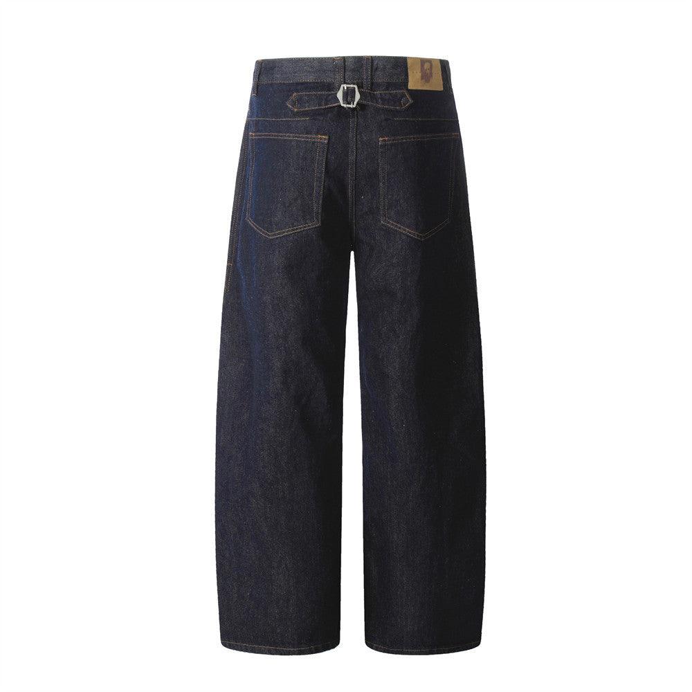 Men's dark denim jeans back view with yoke, belt loops, and patch