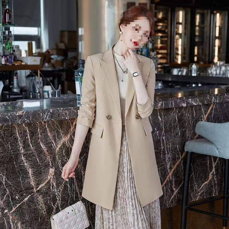 Khaki blazer trench coat with notched lapels, button closure, and side pockets.