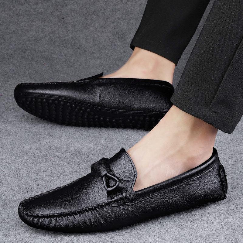 Men's black slip-on loafer with buckle detail and textured rubber sole
