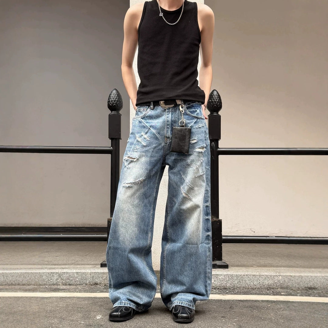Light blue ripped men's wide-leg jeans with distressed knee rips and dark patch pocket