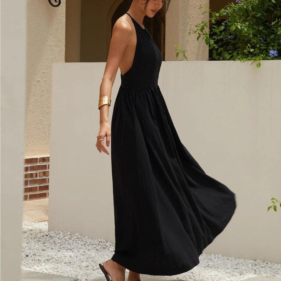 Black sleeveless maxi dress with open back and gathered skirt