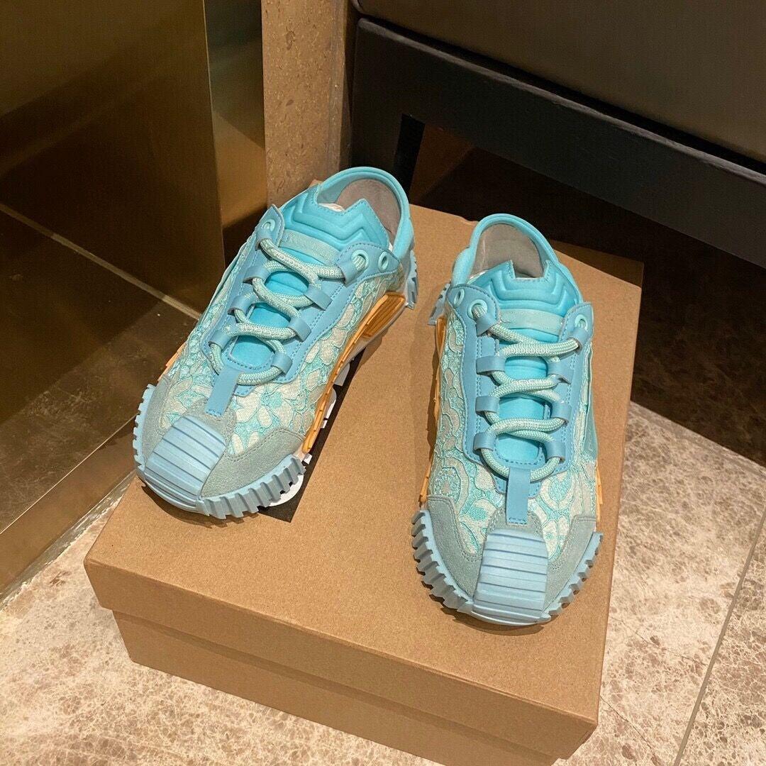 Women’s light blue lace-up casual sneakers with textured panels and orange logo sole