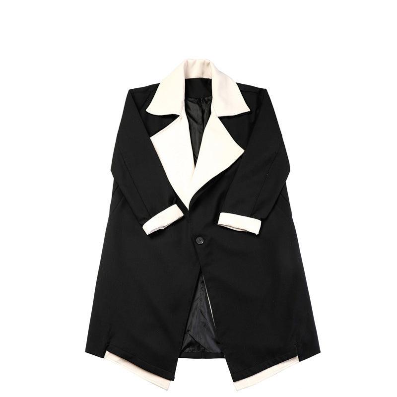 Black coat with cream peak lapels and two-button front, tailored long silhouette