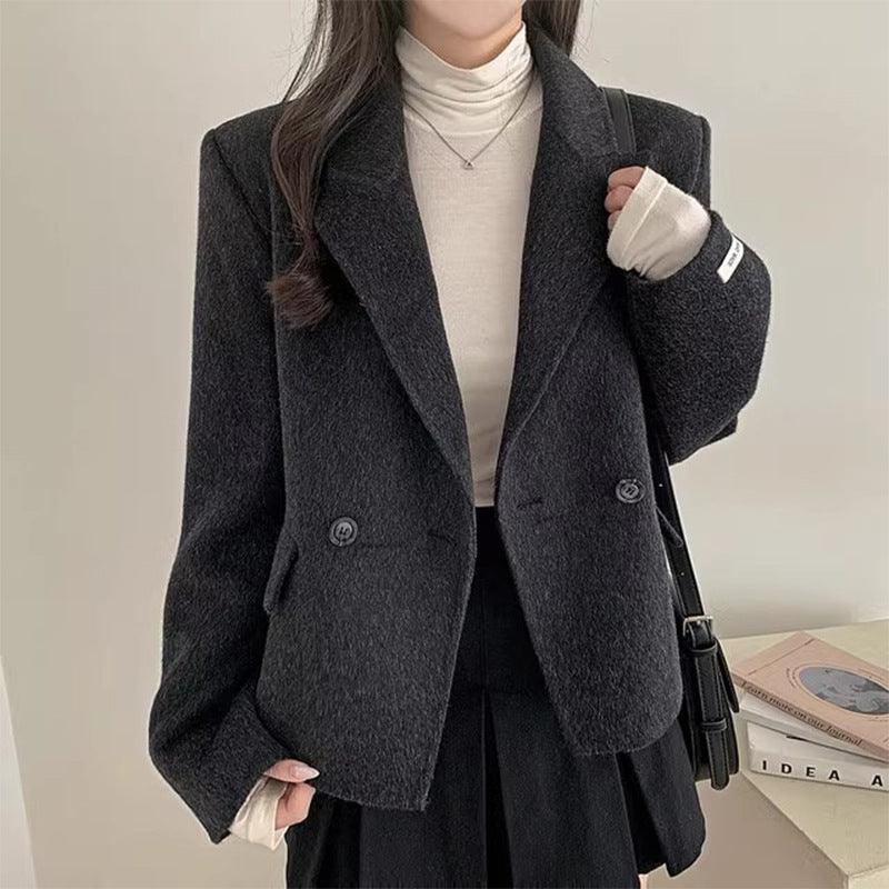 Women's solid black wool jacket with notch lapels and button front