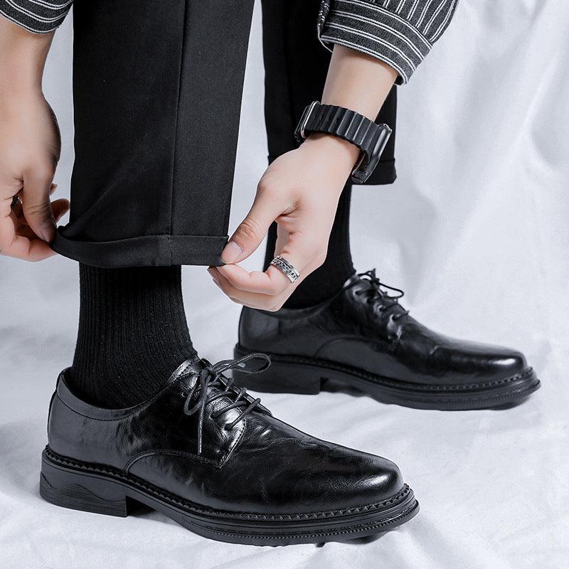 Black leather lace-up oxford shoes with rubber sole and stitched detailing