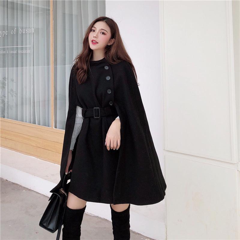 Black woolen cloak coat with button front and belted waist, cape-like silhouette
