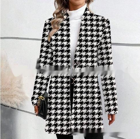 Black-and-white houndstooth trench coat with stand collar, long sleeves, button front.