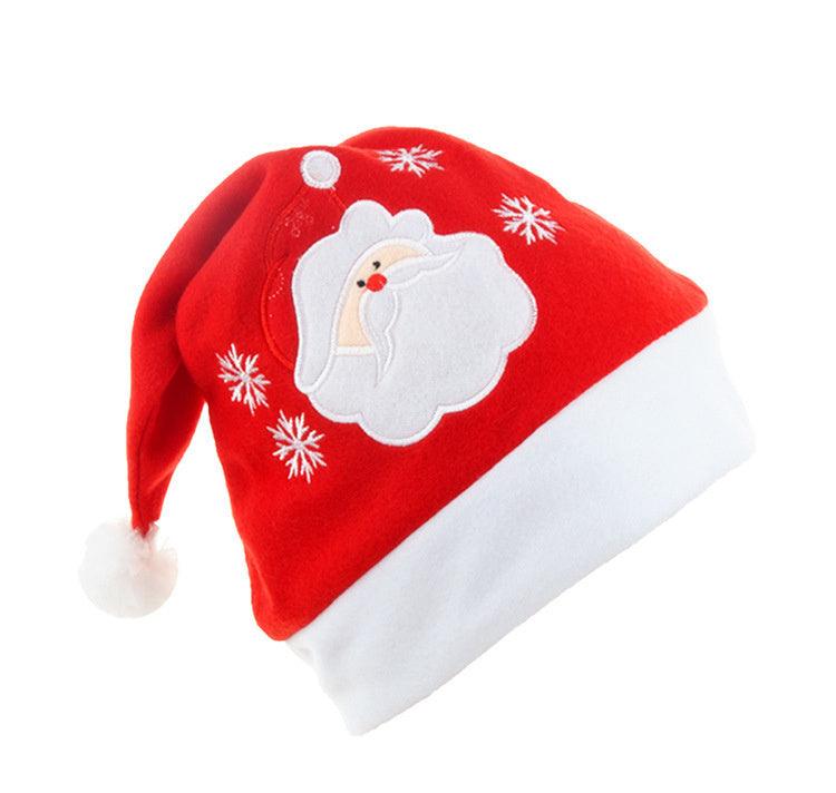 Red cartoon Christmas knit hat with white trim, elk face patch, snowflakes, and white pom