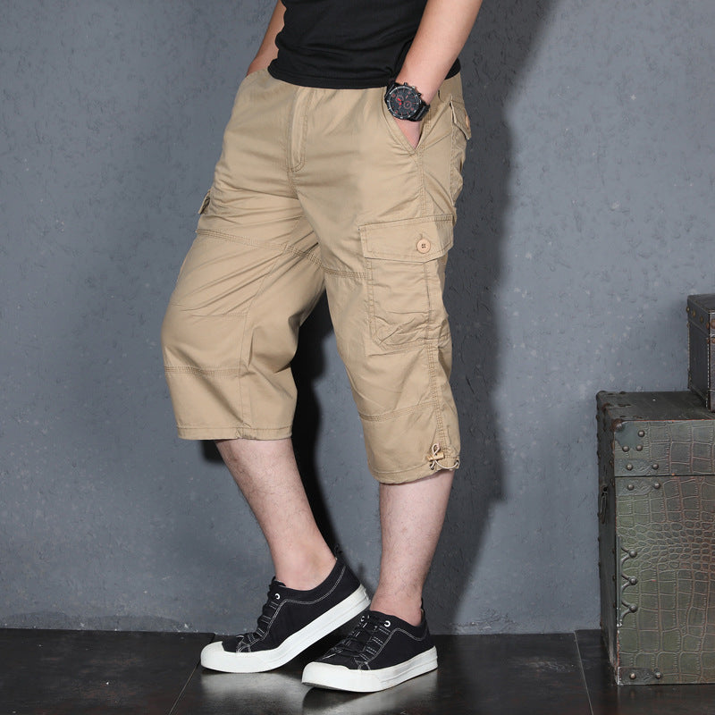 Men's khaki cargo shorts, loose knee-length fit with flap pocket and adjustable hem.
