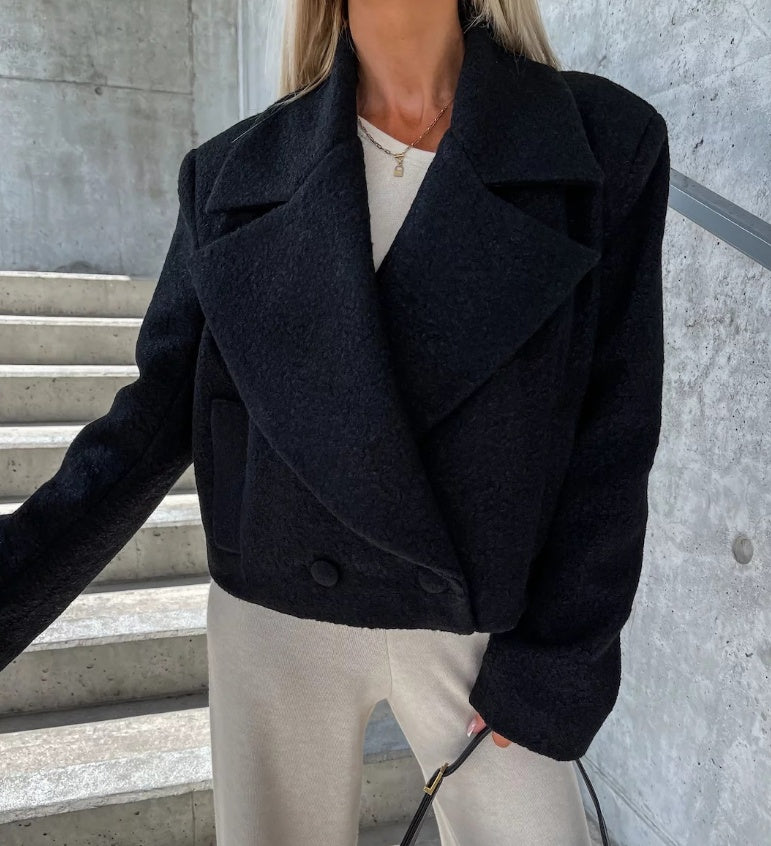 Black cropped oversized wool trench coat with wide lapels and snap front