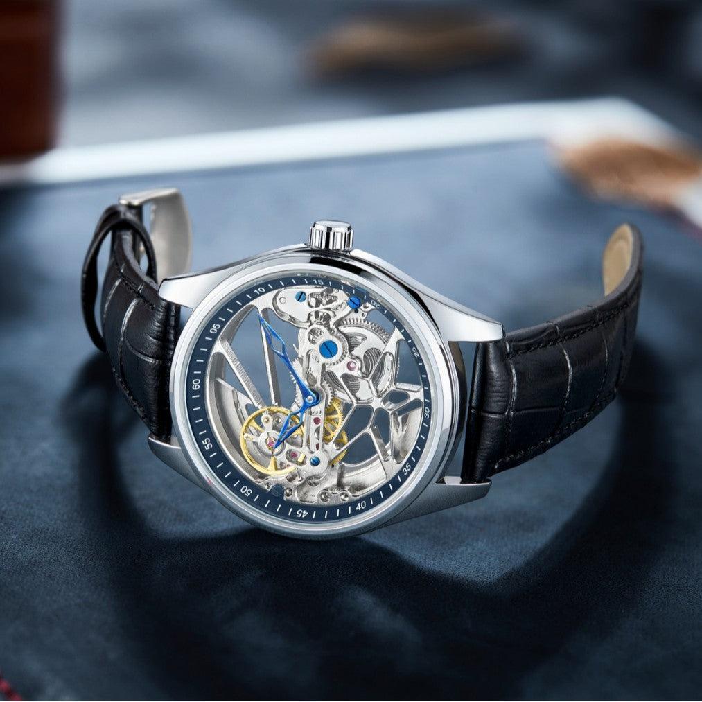 Automatic skeleton mechanical watch with black leather strap, silver case, blue hands