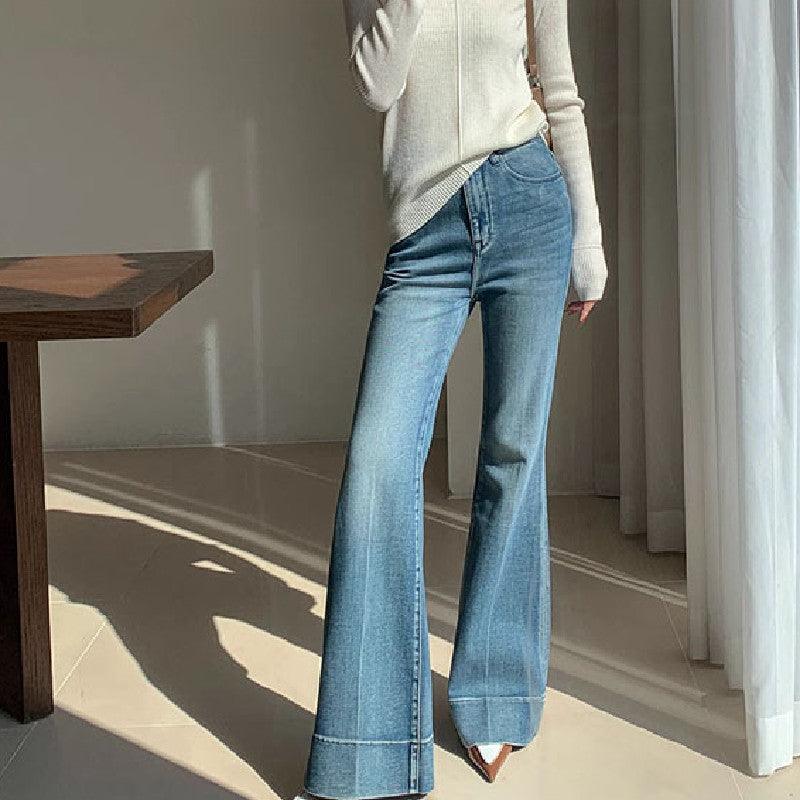 Blue washed women’s flare jeans with wide legs and classic five-pocket design
