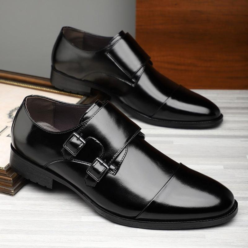 Pointed leather dress shoes in black with two buckle straps and smooth patent-like shine