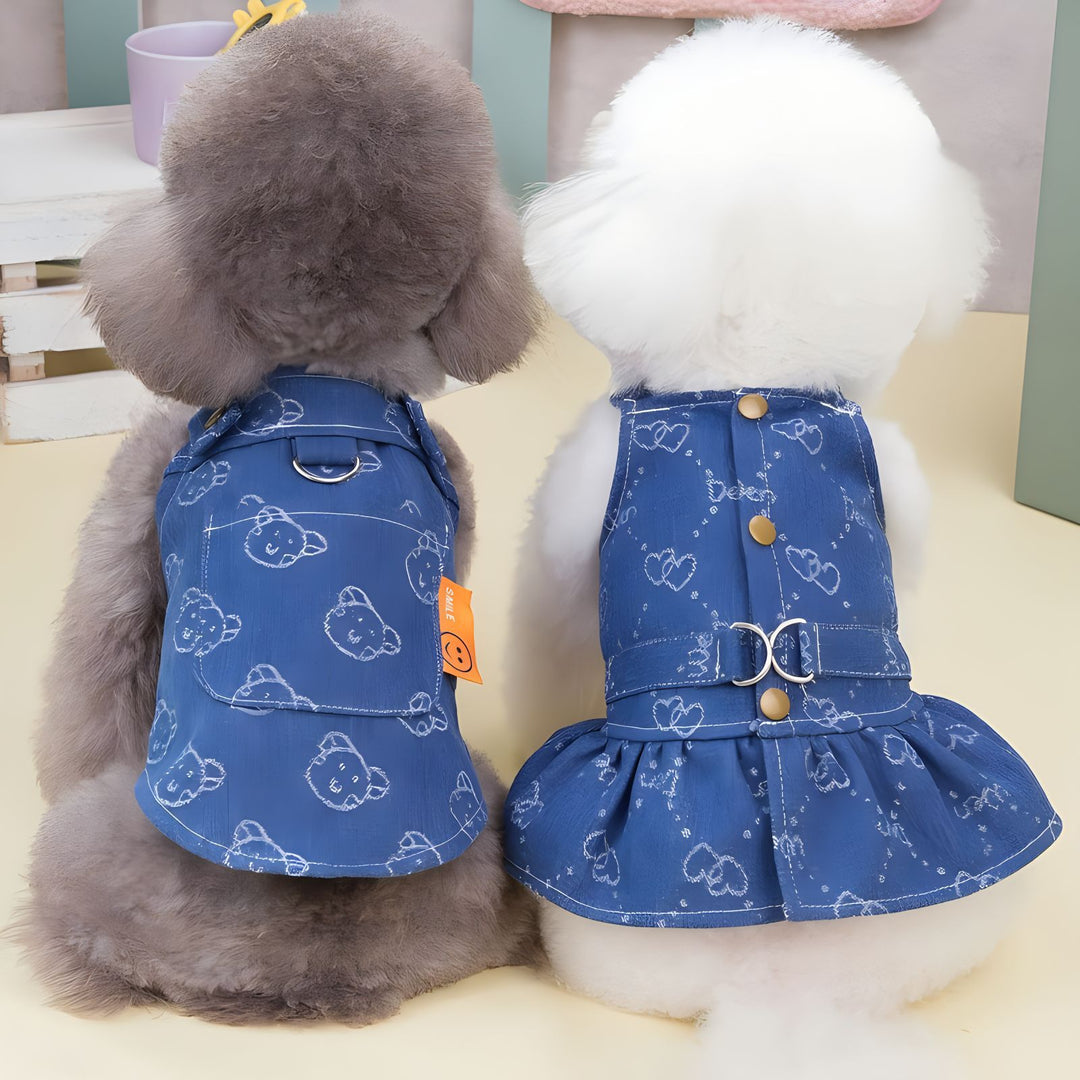 Blue denim dog dress with white heart doodle print, buttoned straps and ruffle hem