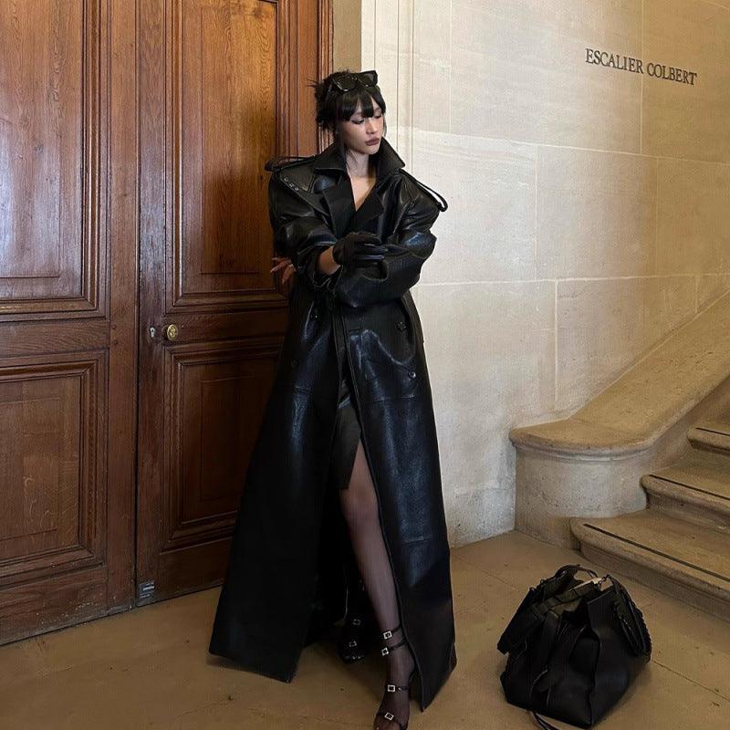 Black long trench coat with wide lapels and open front, belted waist, loose fit.