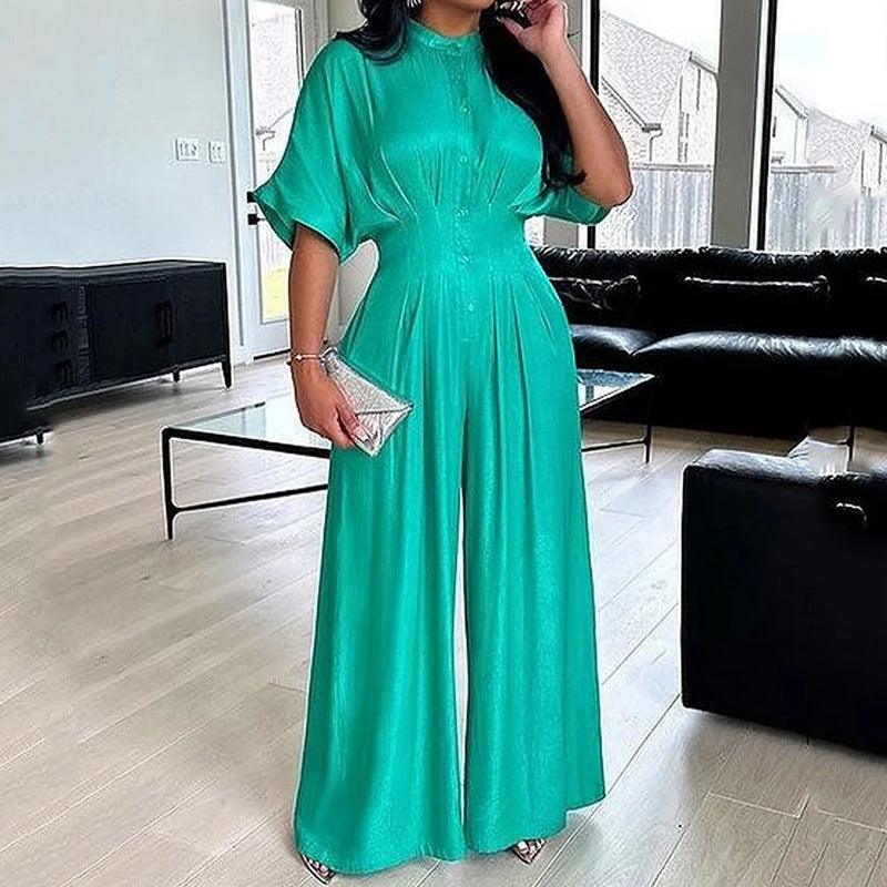 Teal short-sleeve jumpsuit with high neckline, gathered waist, and wide-leg pants