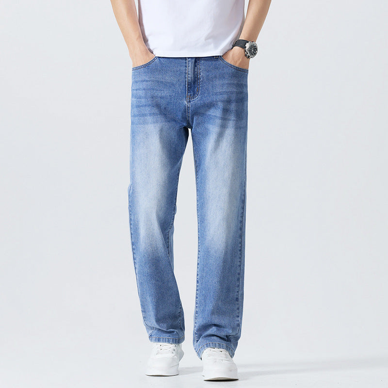 Men's light blue washed denim jeans with straight legs, cuffed hems, and button-zip fly.