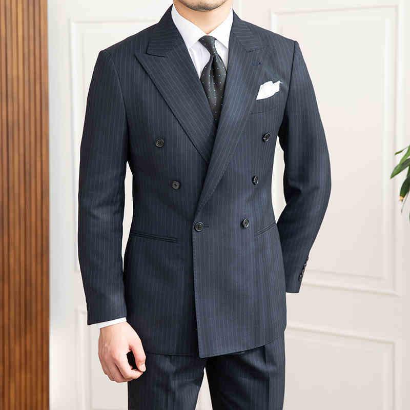 Men's dark pinstripe slim-fit suit, white shirt, patterned tie, pocket square