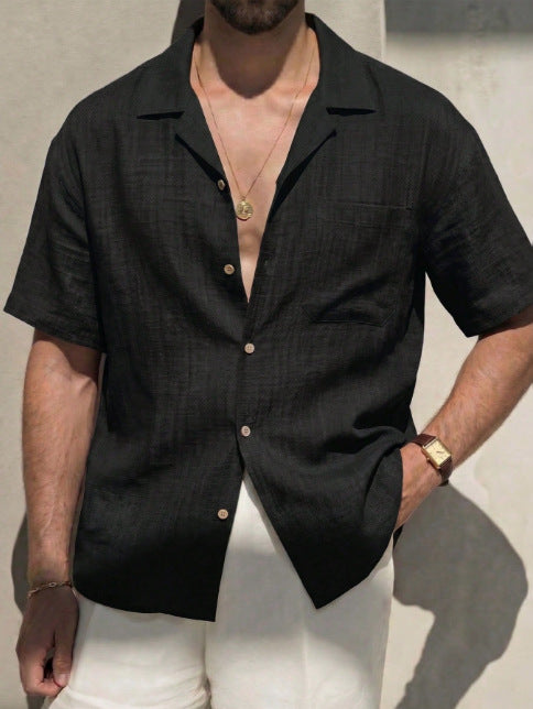 Men's short-sleeve button-up dress shirt in black with open collar and chest pocket