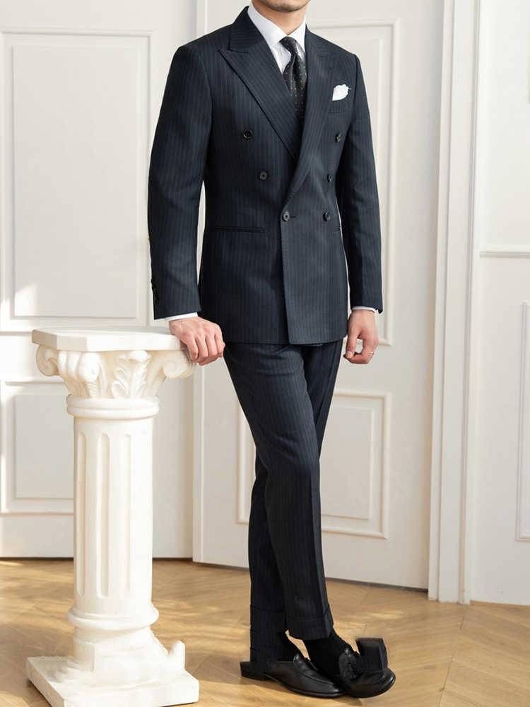 Men's dark pinstripe slim-fit suit with trousers, white shirt, patterned tie, black shoes
