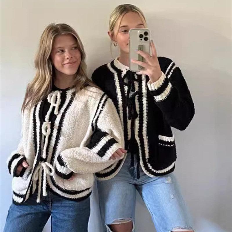 Knitted lace-up pocket sweater coat, cream with black stripes and tassel drawstring