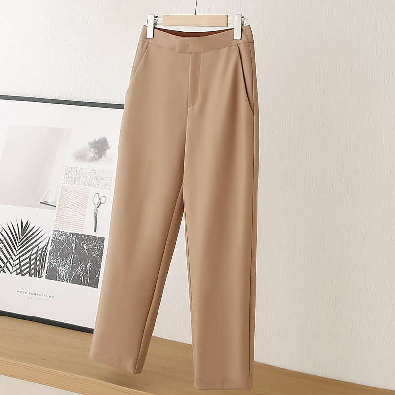 Beige nine-point tapered dress pants with waistband and straight ankle-length legs