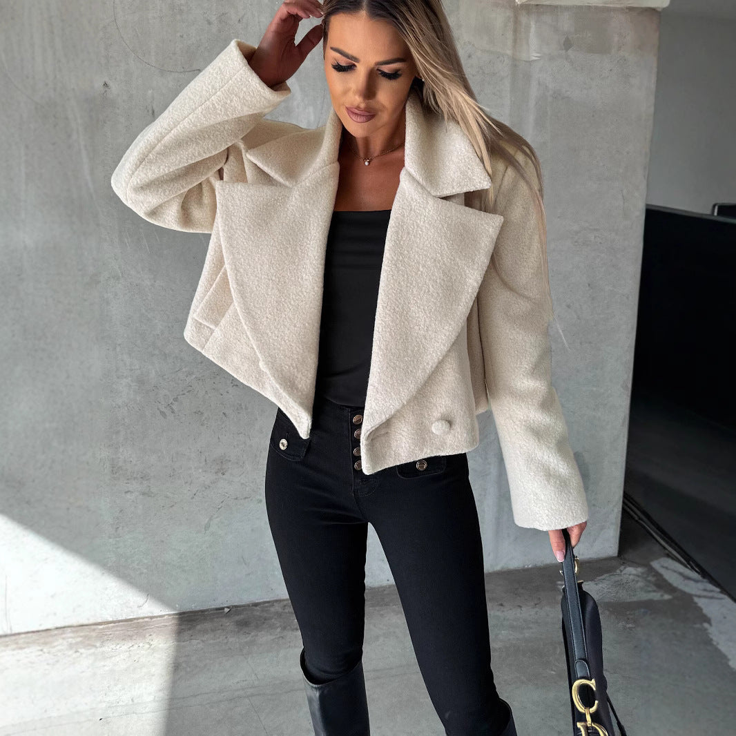 Cream cropped oversized wool trench coat with wide lapels and snap buttons