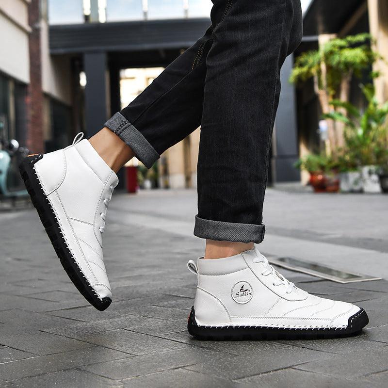 White lace-up high-top leather shoes with textured sole and stitched side panels