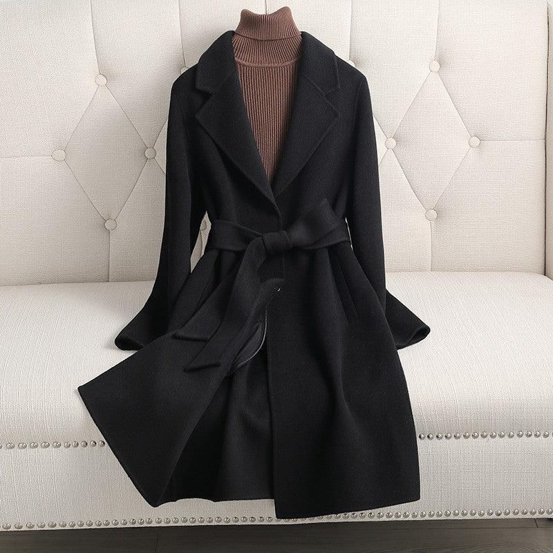 Black double-breasted cashmere coat with notched lapels and tie belt, long sleeves
