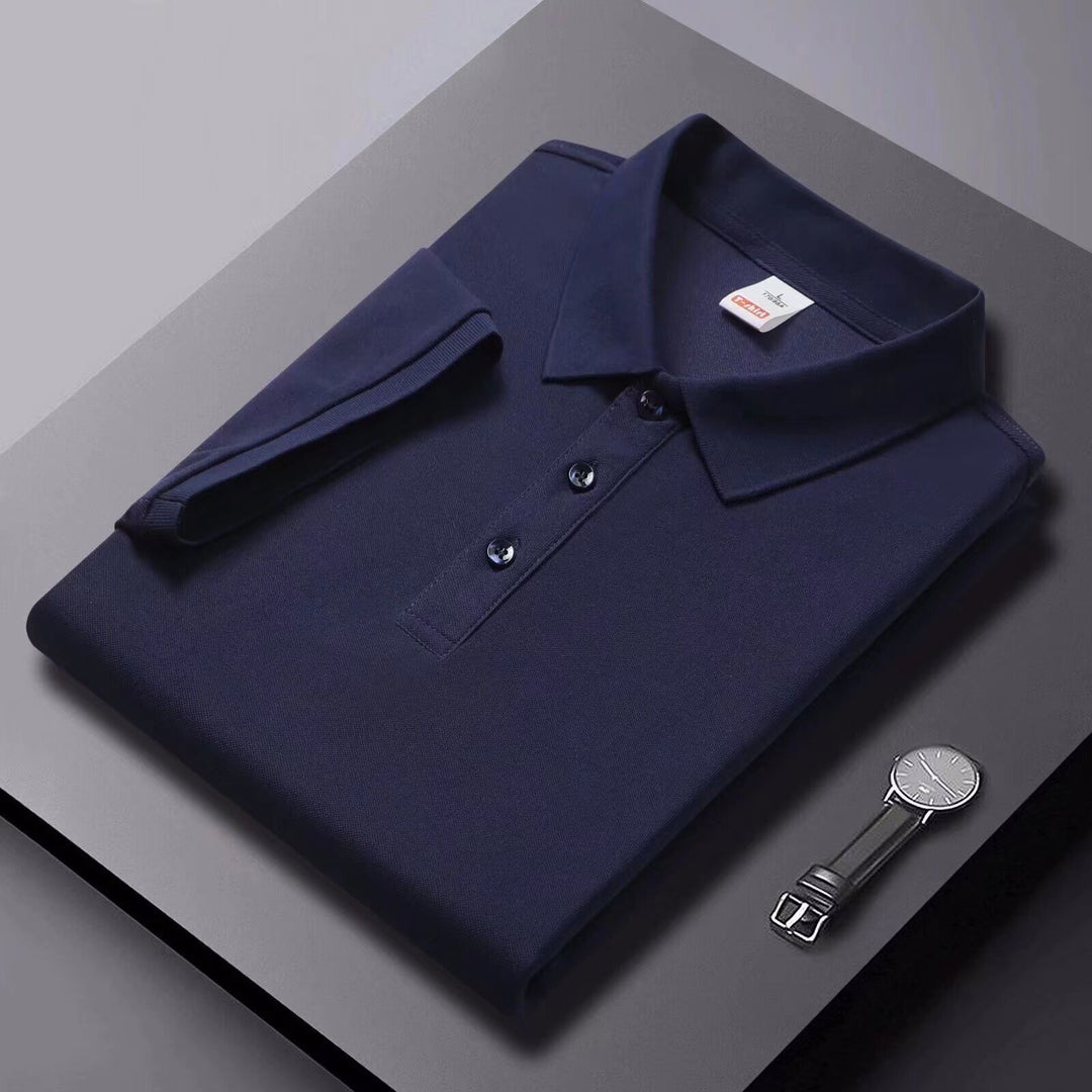 Navy short-sleeve polo shirt with fold-over collar and button placket, flat lay.