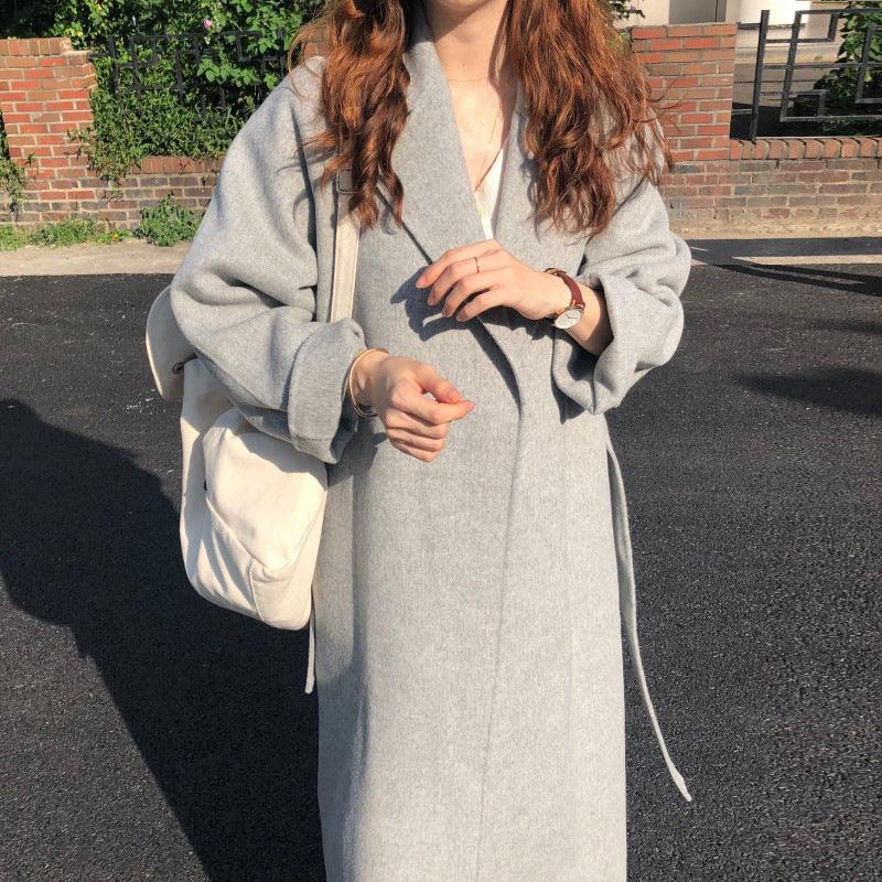 Light grey lapel wool coat with waist tie belt, long relaxed fit