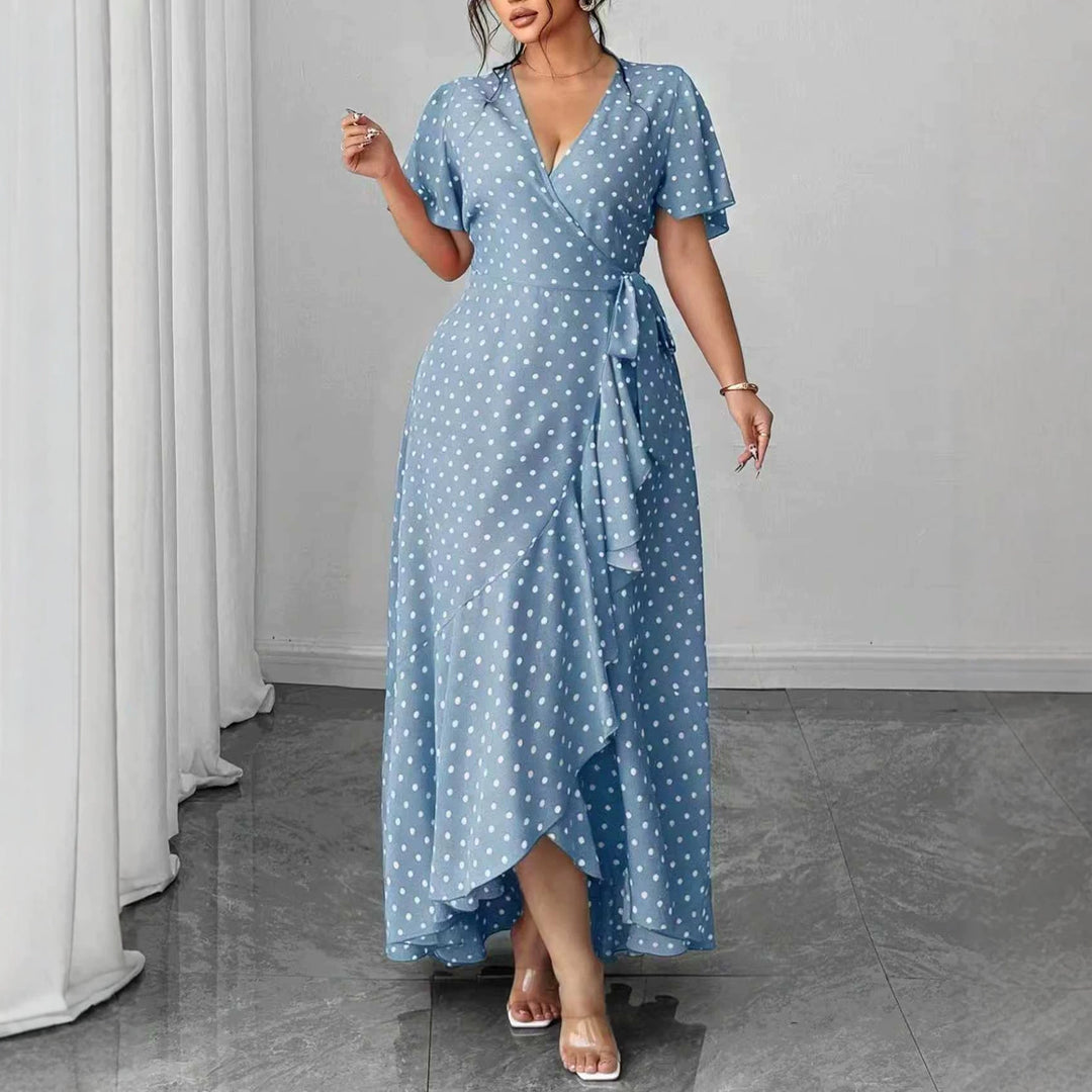 Blue V-neck midi dress with short sleeves, polka dots, and waist tie with layered hem