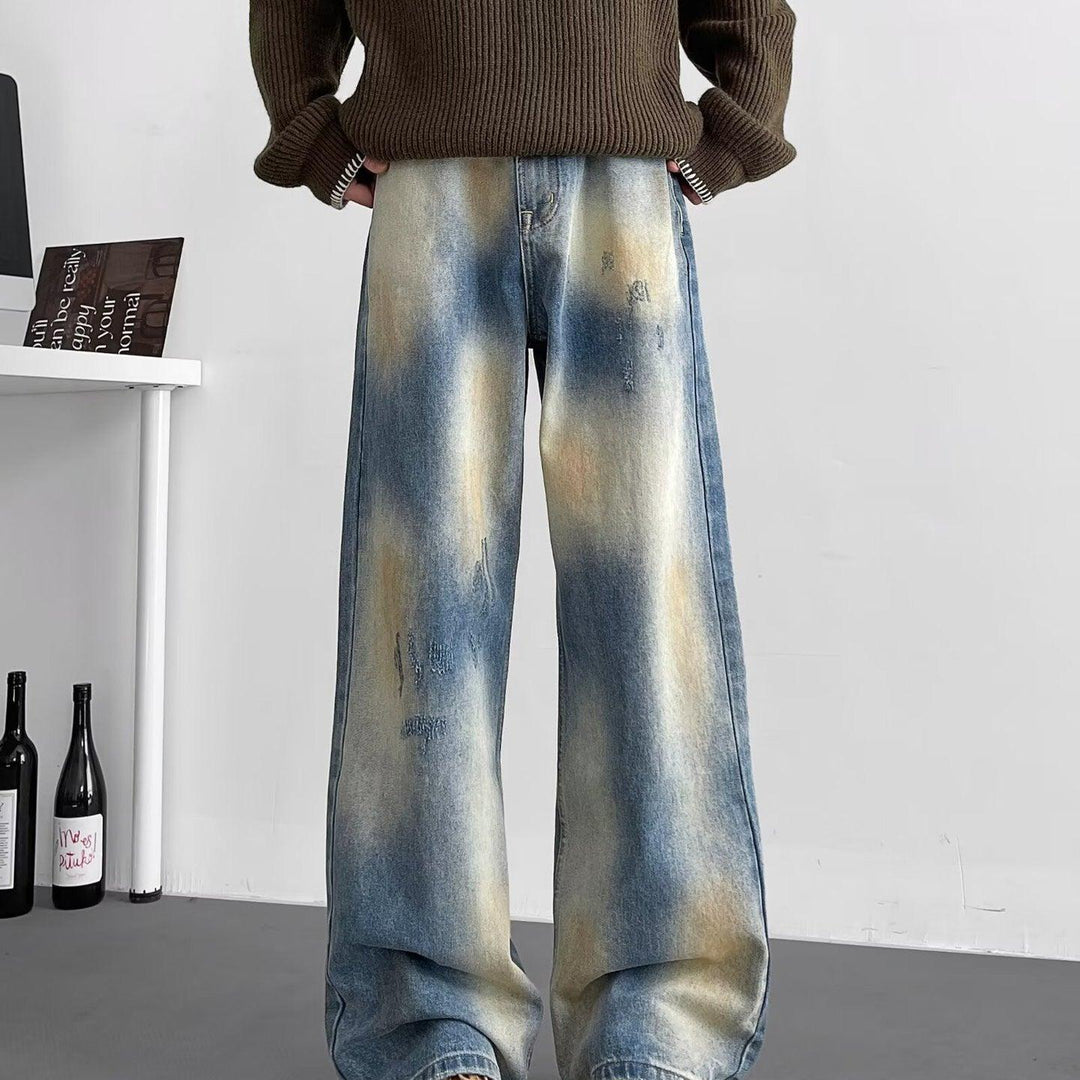 Light blue washed wide-leg jeans with distressed patches and relaxed straight legs