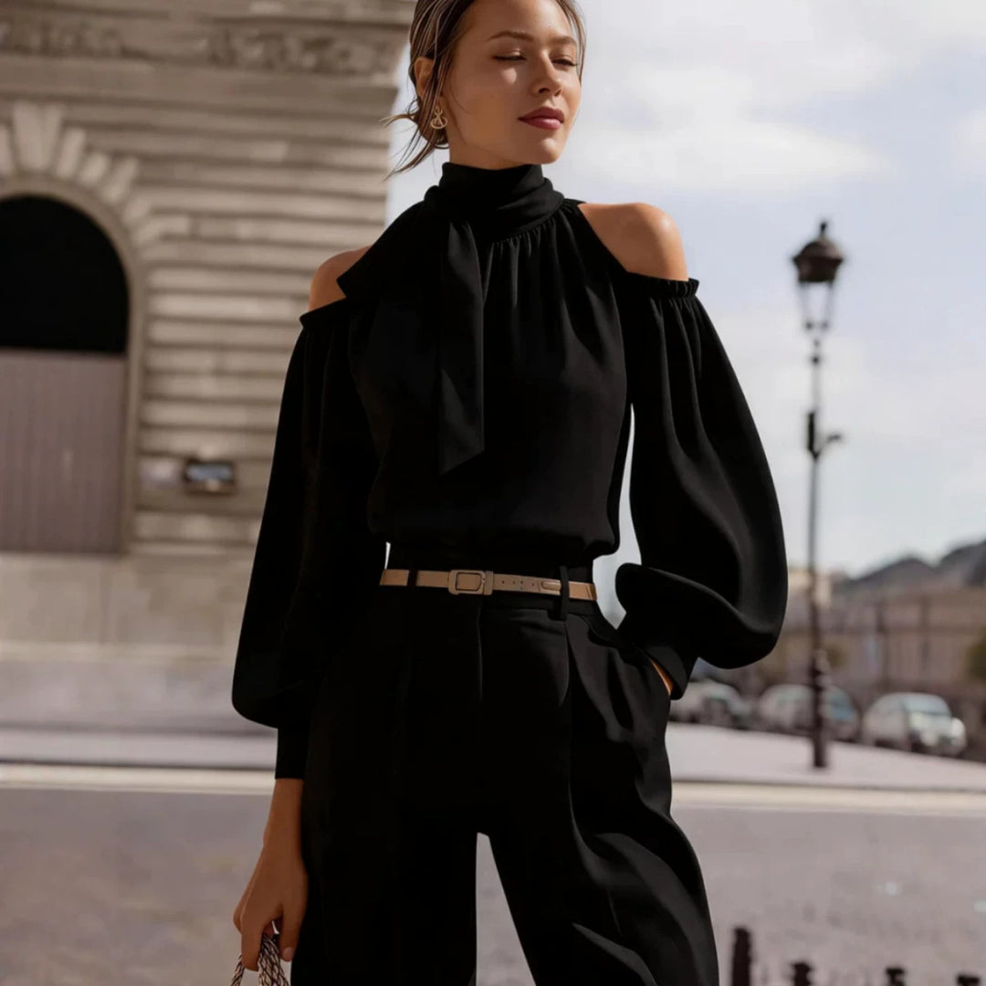 Black off-shoulder stand-collar top with puff sleeves and bow at neckline
