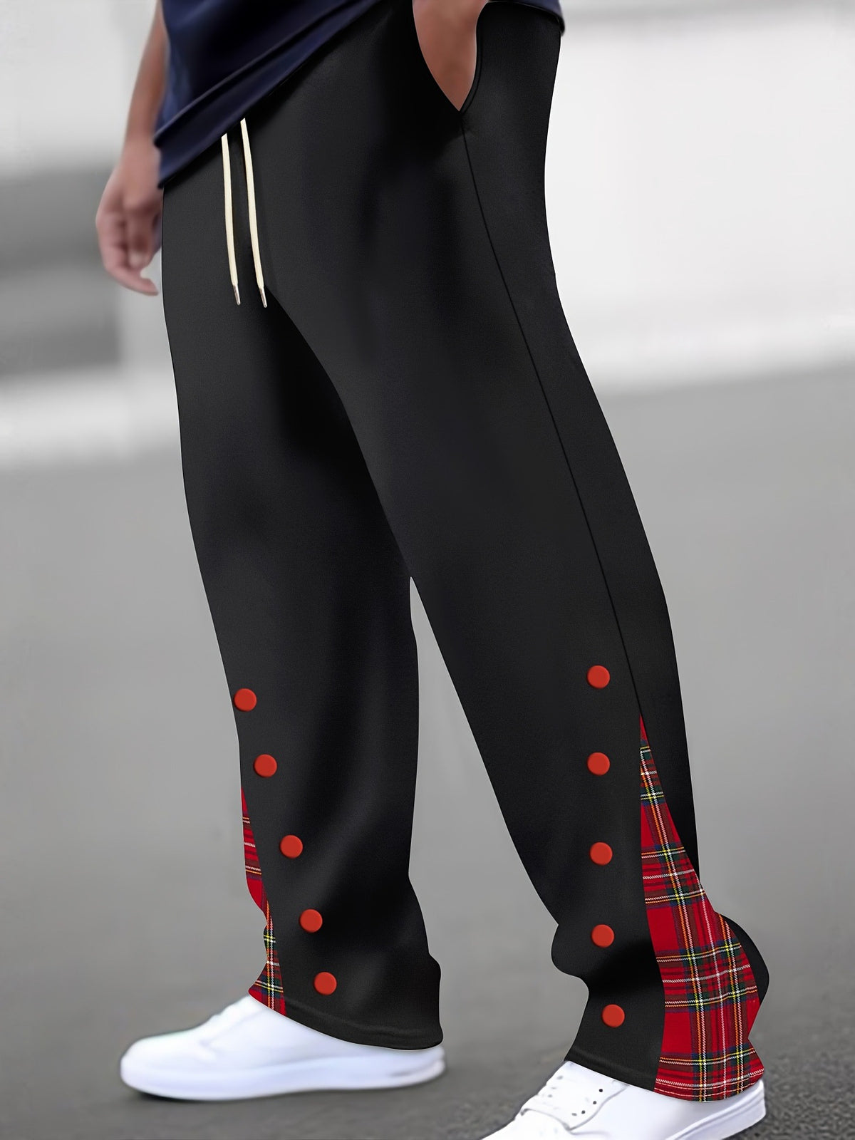 Black color-block trousers with red dot accents and red tartan side panel