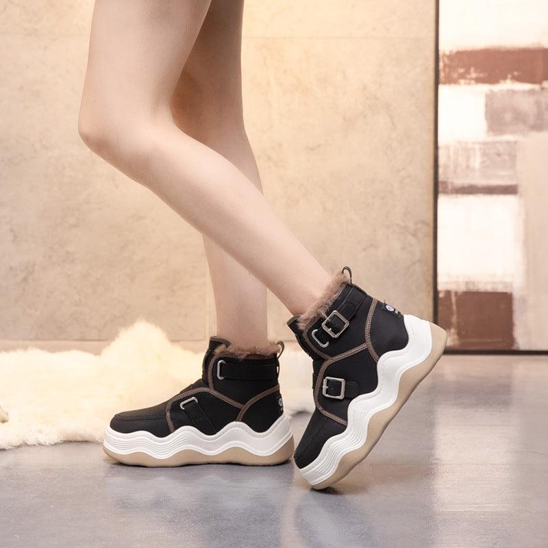 Black high-top elevator sneakers with two buckles and wavy white sole