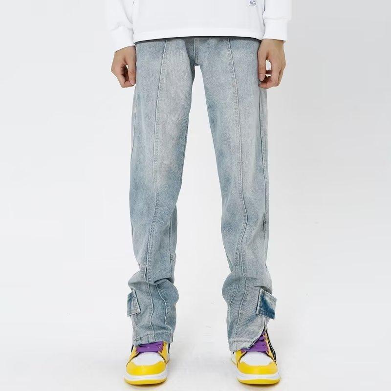 Light blue distressed jeans with zipper fly and worn cuffs at the ankles