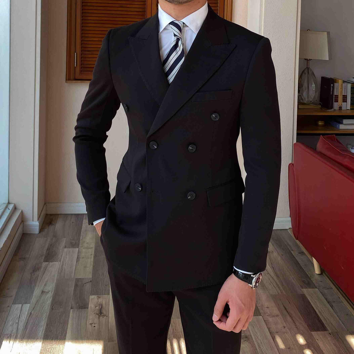 Black double-breasted suit jacket with structured shoulders and buttoned front
