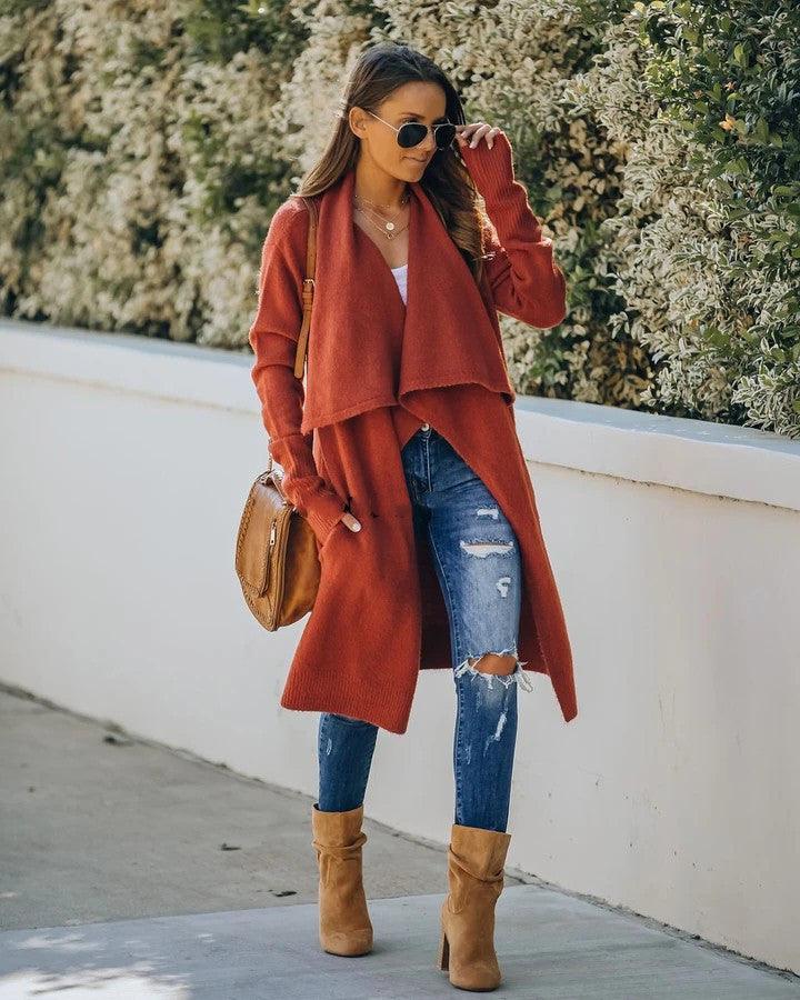 Rust red knitted long coat with draped open front and layered hem