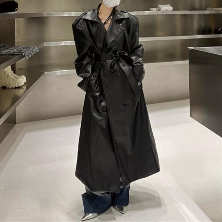 Black mid-length leather coat with tie waist and double-breasted front