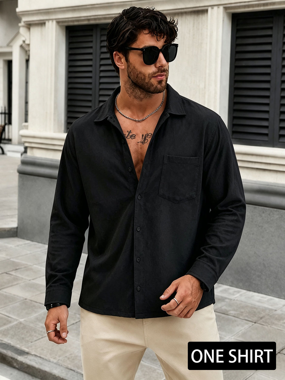 Men's black button-up shirt with chest pocket, long sleeves, collared front.