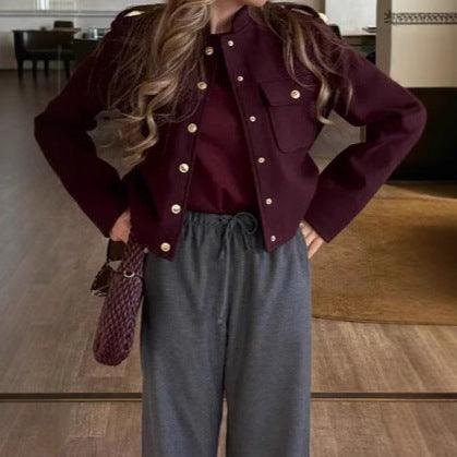 Dark red short jacket with stand collar, gold button front and flap pockets