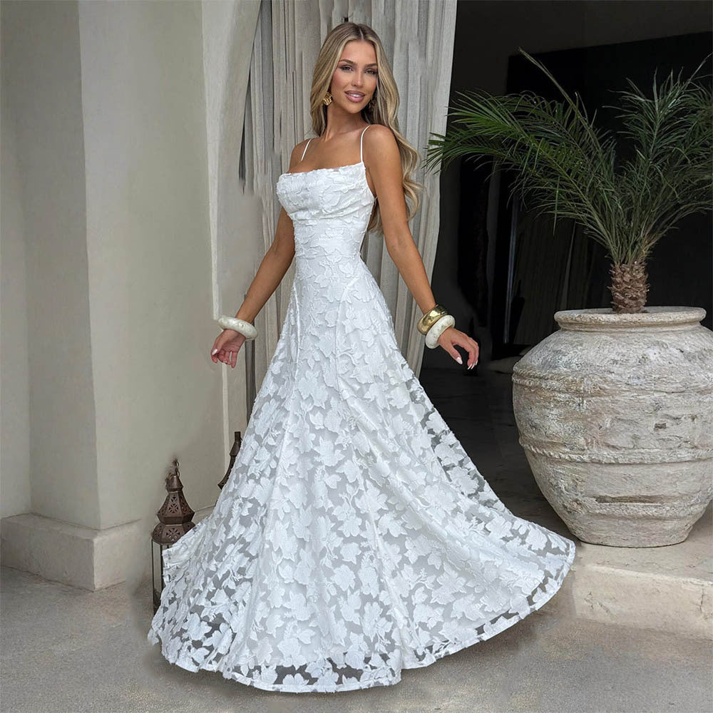 White maxi dress with spaghetti straps and lace floral texture, voluminous skirt