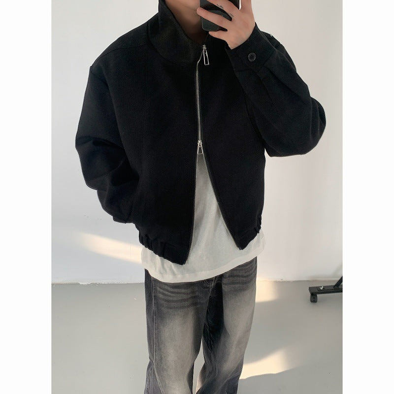 Black zip-up jacket with stand collar, front zipper, buttoned cuffs