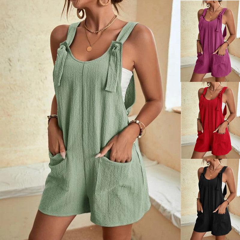Green sleeveless scoop-neck romper with front pocket and side pockets, relaxed fit